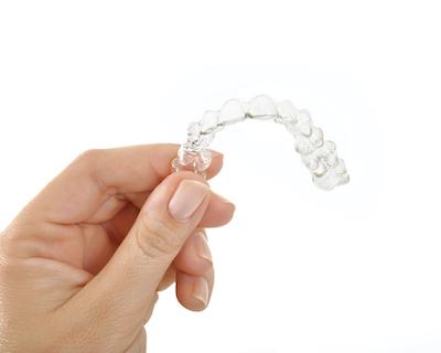 hand holding invisalign 