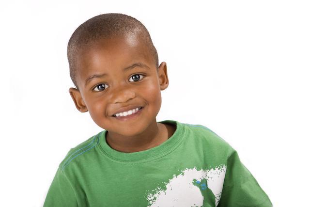 Young boy in green shirt smiling in barrie