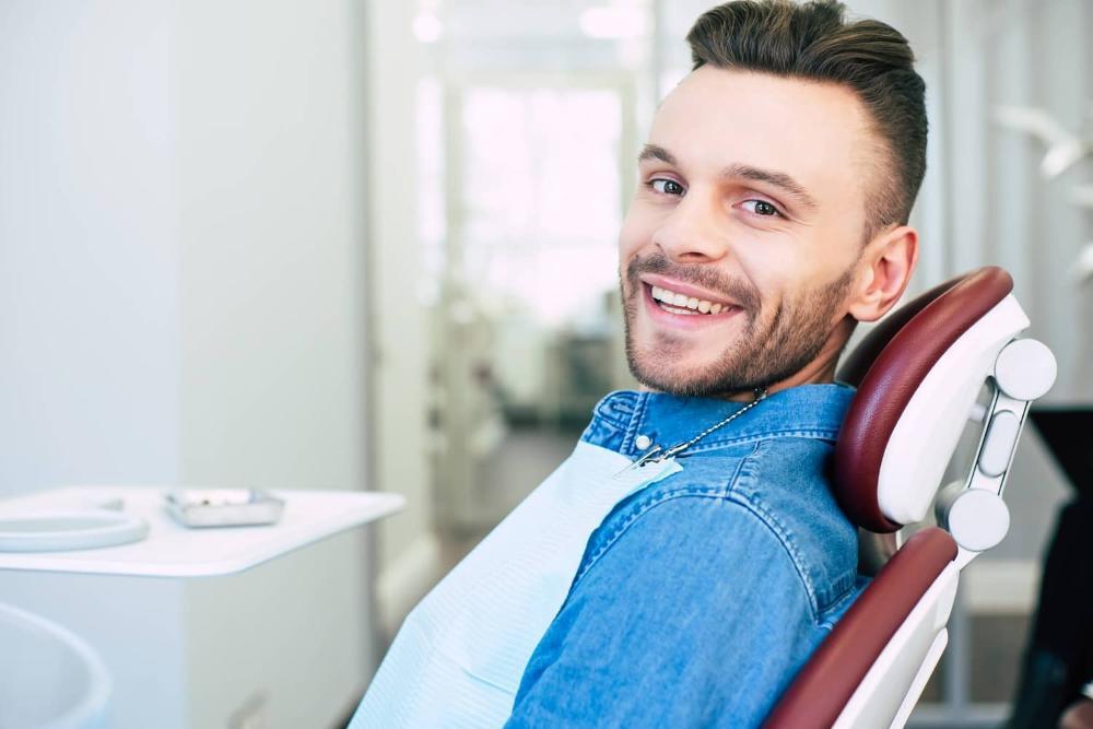 man smiling in dental chair in Barrie