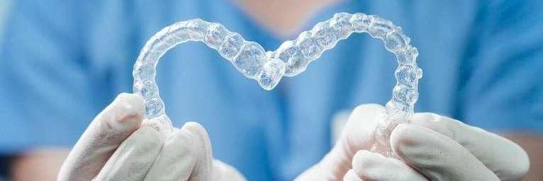 close up of two invisalign aligners making a heart shape