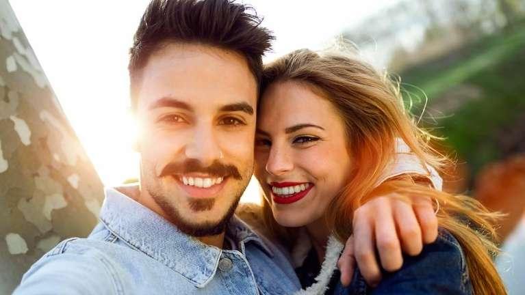 man and woman smiling in a park in Barrie