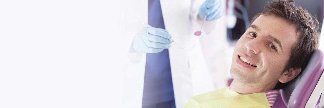 Man sitting in dental chair smiling 