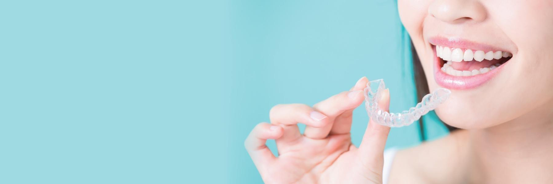 Woman holding invisalign from Barrie dentist