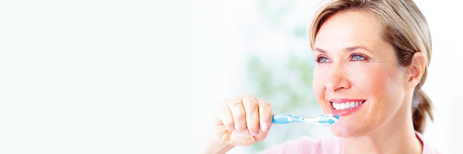 Woman brushing her teeth in barrie on