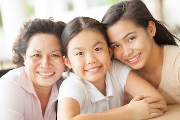 mother, grandmother, and daughter smiling